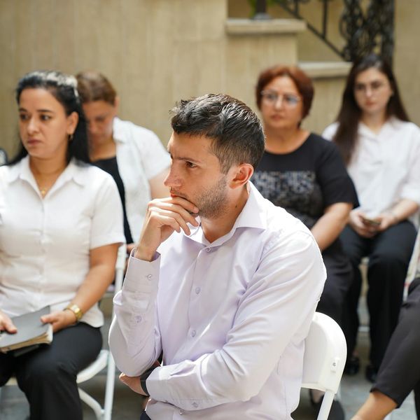 A group of men engaged in a focused group training session.